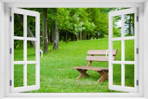 Fototapeta Naklejka Na Ścianę Okno 3D - Cozy wooden bench on a green lawn