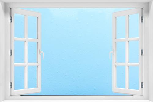 Fototapeta Naklejka Na Ścianę Okno 3D - Drops, water splashes on blue background. Cute simple background, backdrop. Top view. Close-up. Stock photo