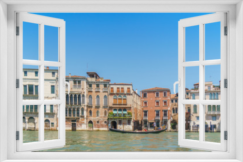 Fototapeta Naklejka Na Ścianę Okno 3D - Venetian landscape with typical buildings, Grand canal and gondola at noon time.