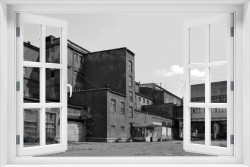 Fototapeta Naklejka Na Ścianę Okno 3D - Cyprian buildings of an old factory of the Soviet period. Monochrome image