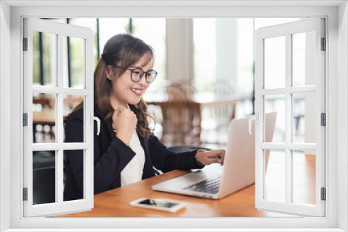 Asian young business freelance woman happiness working online business with laptop and cell phone in cafe shop. Working, Success, happiness concept.