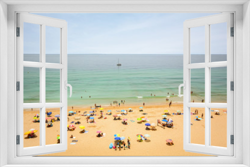 Fototapeta Naklejka Na Ścianę Okno 3D - View from the cliffs to busy beach Praia do Porto de Mos near Ponta da Piedade, Lagos Algarve Portugal