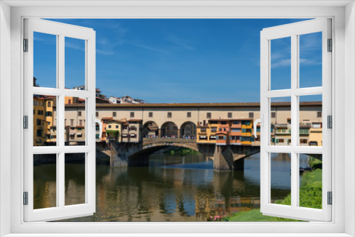 Fototapeta Naklejka Na Ścianę Okno 3D - River Arno and famous bridge Ponte Vecchio (The Old Bridge) at sunny summer day. Florence, Tuscany, Italy