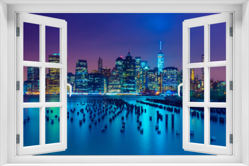 Fototapeta Naklejka Na Ścianę Okno 3D - New York City at night. Manhattan skyline. Skyscrapers reflected in water. NY, USA
