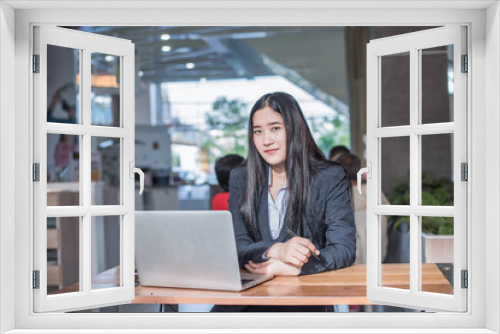 Asian young business freelance woman happiness working online business with laptop and cell phone in cafe shop. Working concept.