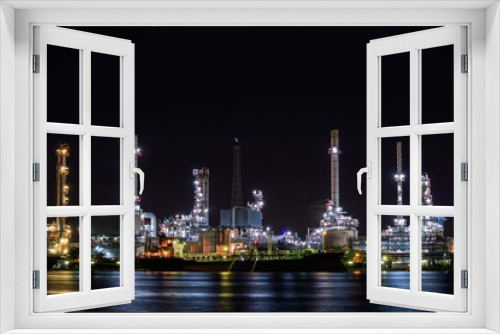 Fototapeta Naklejka Na Ścianę Okno 3D - Oil refinery plant near river at twilight, Business and  Industry concept