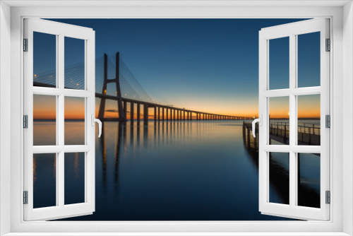 Fototapeta Naklejka Na Ścianę Okno 3D - Sunrise in Lisbon, under the Vasco da Gama Bridge, portugal