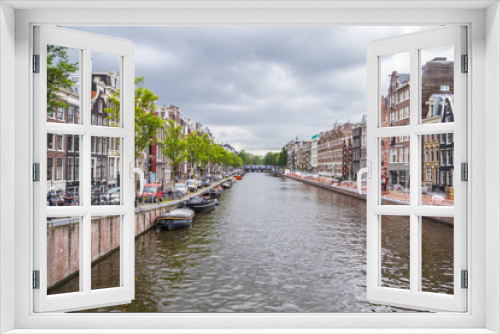 Fototapeta Naklejka Na Ścianę Okno 3D - The amazing canals in the city center of Amsterdam - very romantic - AMSTERDAM - THE NETHERLANDS - JULY 20, 2017