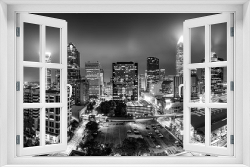 Fototapeta Naklejka Na Ścianę Okno 3D - Black and white, aerial view of Charlotte, NC skyline on a foggy night. Charlotte is the largest city in the state of North Carolina and the 17th-largest city in the United States