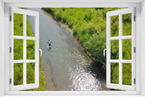 Fototapeta Naklejka Na Ścianę Okno 3D - Aerial view of fly fisherman fishing in Montana river