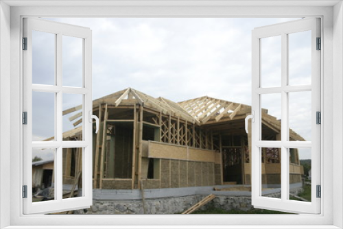 Fototapeta Naklejka Na Ścianę Okno 3D - Frame house made of straw. Facade