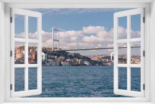 Fototapeta Naklejka Na Ścianę Okno 3D - Istanbul, Turkey.  View of the Fatih Sultan Mehmet Bridge and residental buildings sailing Bosporus.
