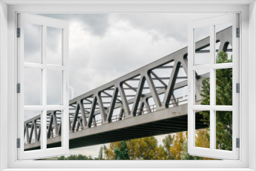 Fototapeta Naklejka Na Ścianę Okno 3D - modern steel bridge with green trees