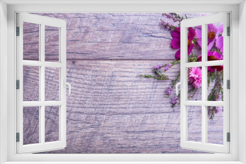 Fototapeta Naklejka Na Ścianę Okno 3D - A bouquet of pink and purple flowers cosmea or cosmos with ribbon on rustic wooden boards. Copy space. Mother's, Valentines, Women's, Wedding Day concept