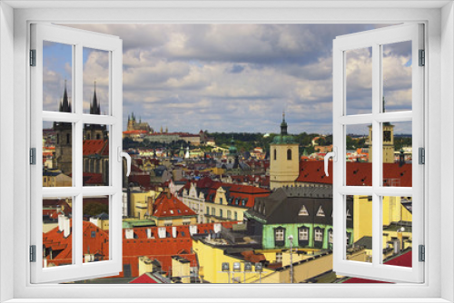 Fototapeta Naklejka Na Ścianę Okno 3D - Amazing view of the center of Prague from the Powder Tower. In the foreground there are towers of Church of Our Lady before Tyn. On the horizon is visible Prague Castle with St. Vitus Cathedral