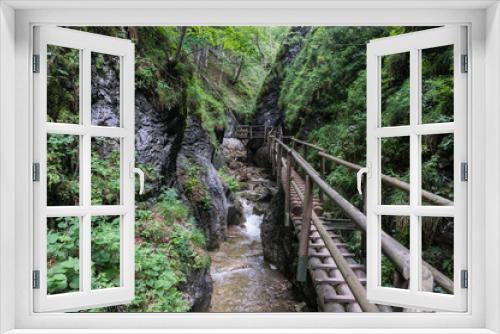 Fototapeta Naklejka Na Ścianę Okno 3D - Wooden path running along the cliff and over the river gorge
