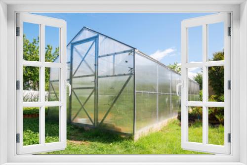Fototapeta Naklejka Na Ścianę Okno 3D - Greenhouse made of polycarbonate with a triangular roof