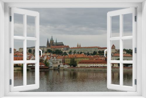 Cityscape view on the riverside with the bridge and old town in Prague