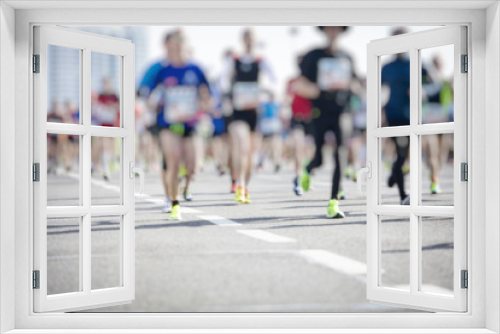 marathon runners ,motion blur running people in the city
