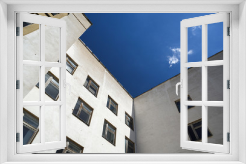 Fototapeta Naklejka Na Ścianę Okno 3D - White building with square windows against blue sky