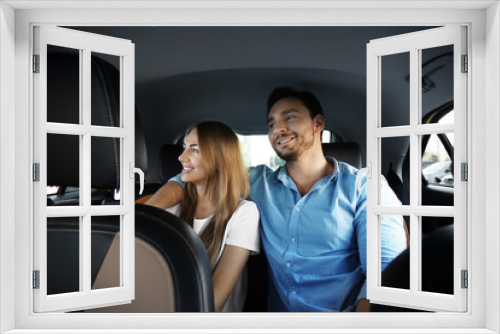 Young couple sitting in taxi car