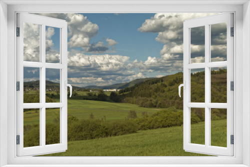Fototapeta Naklejka Na Ścianę Okno 3D - Picturesque hills covered with forests against a background of white clouds