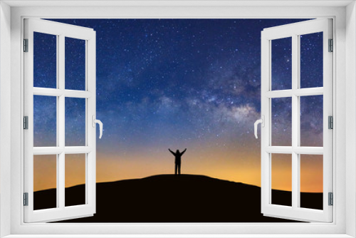 Fototapeta Naklejka Na Ścianę Okno 3D - Panorama landscape with milky way, Night sky with stars and silhouette of a standing sporty man with raised up arms on high mountain.