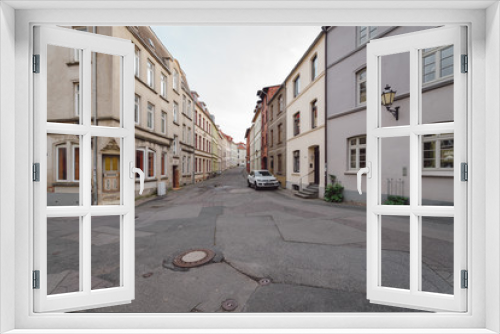 Fototapeta Naklejka Na Ścianę Okno 3D - street amidst houses against sky