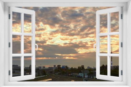 Fototapeta Naklejka Na Ścianę Okno 3D - Cityscape at sunset with the clouds at background