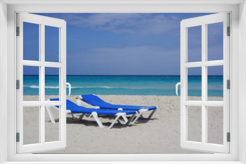 Fototapeta Naklejka Na Ścianę Okno 3D - Two blue lounge chairs on a beach in Cuba