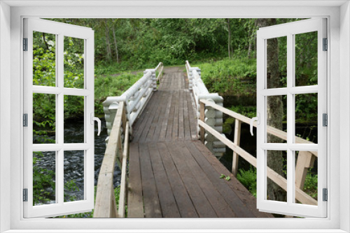 Fototapeta Naklejka Na Ścianę Okno 3D - Wooden bridge across the river in the forest