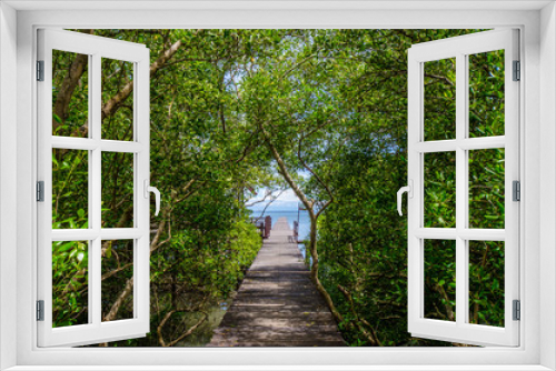 Fototapeta Naklejka Na Ścianę Okno 3D - Wooden walkway in the mangrove forest to the sea.