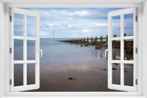 Fototapeta Naklejka Na Ścianę Okno 3D - Long exposure at Portobello beach with groynes and a calm sea