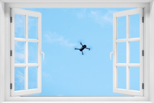 Fototapeta Naklejka Na Ścianę Okno 3D - Modern drone hovering in blue sky