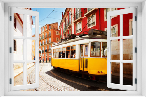 Fototapeta Naklejka Na Ścianę Okno 3D - yellow tram on narrow street of Alfama district, Lisbon, Portugal, retro toned