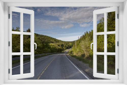 Fototapeta Naklejka Na Ścianę Okno 3D - Empty road amidst trees by hills, Ceilidh Trail, Cape Breton Island, Nova Scotia, Canada