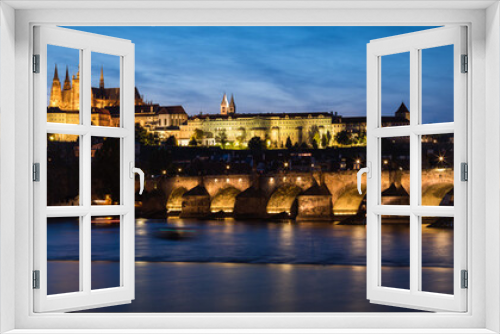 Cityscape of Prague Castle and Charles Bridge at dusk