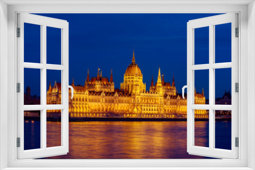 Fototapeta Naklejka Na Ścianę Okno 3D - Budapest Parliament building and Danube river at night with illumination, travel sightseeing background