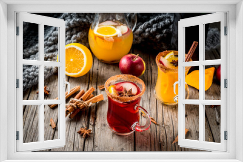 Fototapeta Naklejka Na Ścianę Okno 3D - Traditional fall and winter drinks and cocktails. White and red autumn hot spicy sangria with anise, cinnamon, apple, orange, wine. In glass mugs, old rustic wooden table. Selective focus copy space
