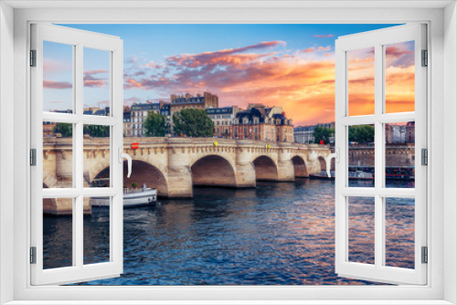 Famous Pont Neuf in Paris, France. Spectacular cityscape with dramatic sunset sky. Travel background.