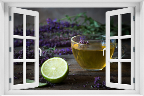 Fototapeta Naklejka Na Ścianę Okno 3D - Green tea with herbals and lime. Tea with oregano on the wooden background