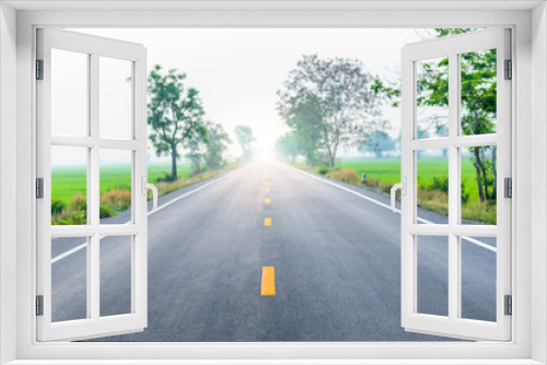 Fototapeta Naklejka Na Ścianę Okno 3D - Empty country road through the agricultural fields in the morning