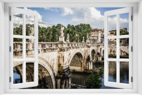 Saint Angel bridge with mirror reflection in Tiber river  in Rome, Italy.
