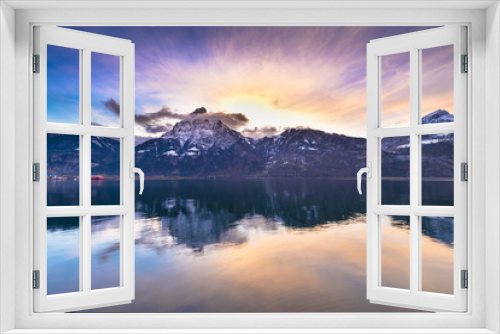 Fototapeta Naklejka Na Ścianę Okno 3D - Bright sunset colors. Swiss Alps. Colorful sunset over the mountains and lake. Tops in the snow reflected in lake water.