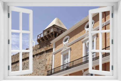 Fototapeta Naklejka Na Ścianę Okno 3D - View of historical building and wall of fortress in Ibiza.