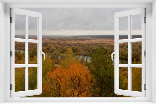 Fototapeta Naklejka Na Ścianę Okno 3D - Autumn colorful foliage over lake with beautiful woods in red and yellow color.