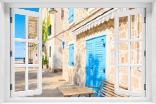 Fototapeta Naklejka Na Ścianę Okno 3D - Small table in front of coastal restaurant with blue windows old town of Primosten, Dalmatia, Croatia