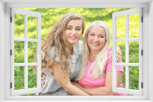 Young woman and her mother together in park