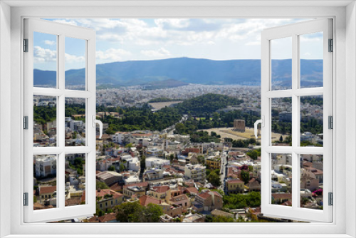 Panoramic view of Athens city from Acropolis seeing ancient ruin, building architecture, urban street, trees, mountain and bright sky background