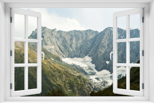 Fototapeta Naklejka Na Ścianę Okno 3D - View of a melting glacier in a mountain valley